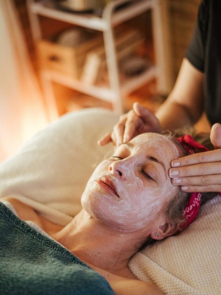 Tranquil scene of a woman receiving a facial treatment in a serene spa setting.